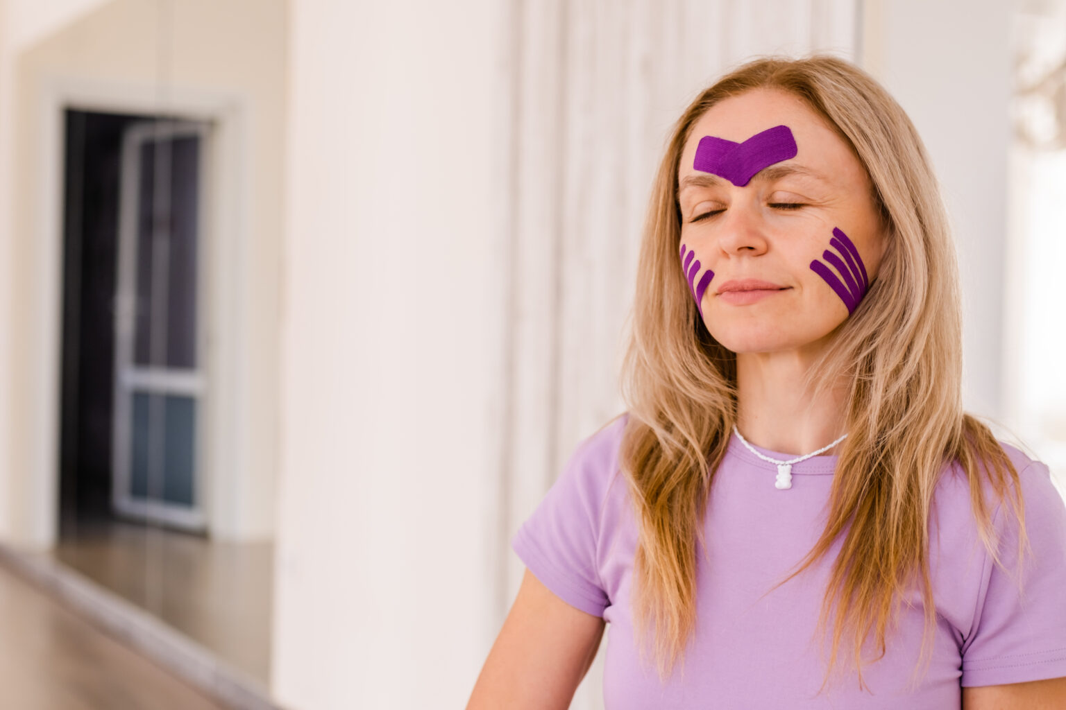 woman 30 -40 years old applying lifting tape . concept of facial rejuvenation, Kinesiotaping for