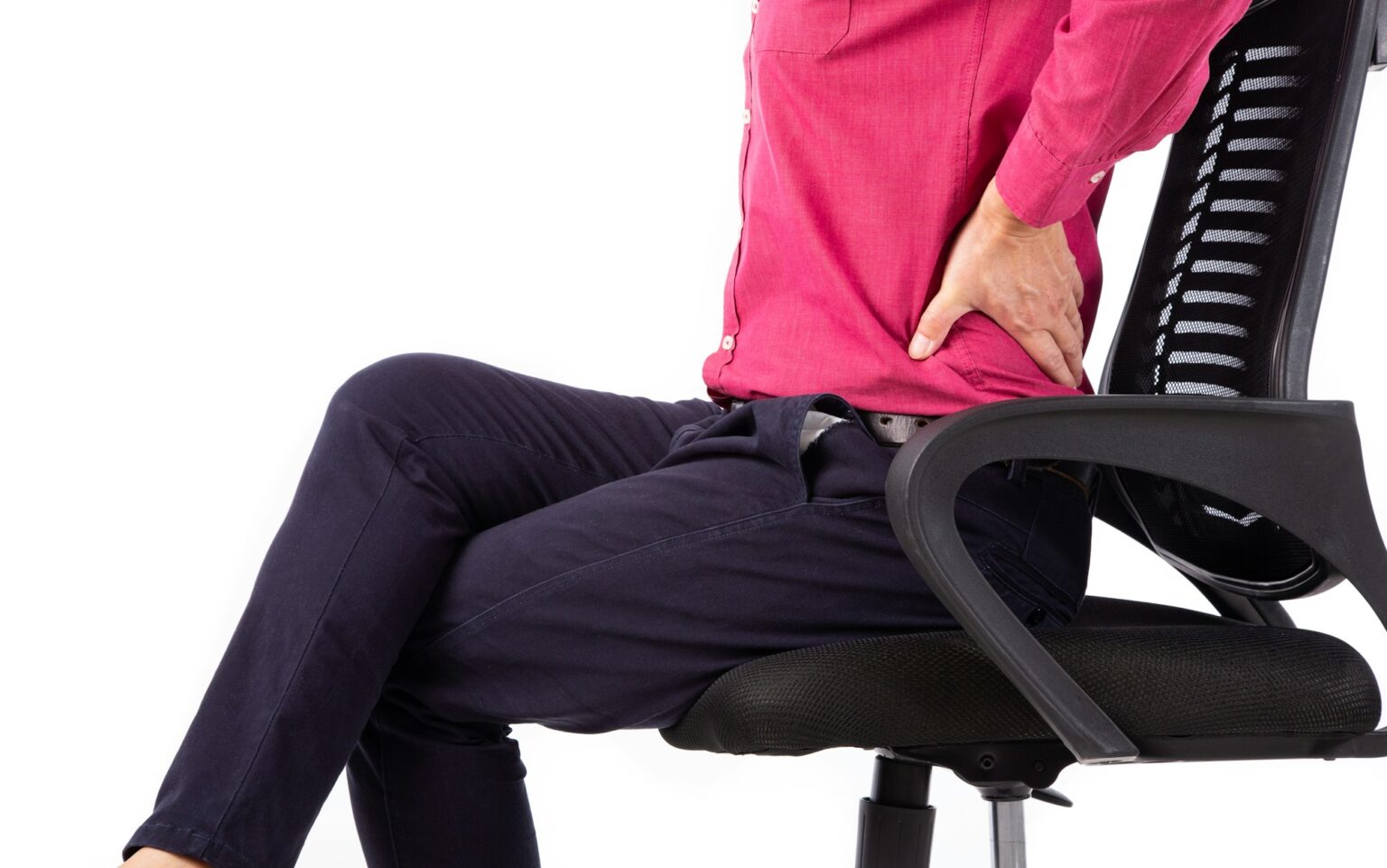 Business man with back pain sitting in an office chair.